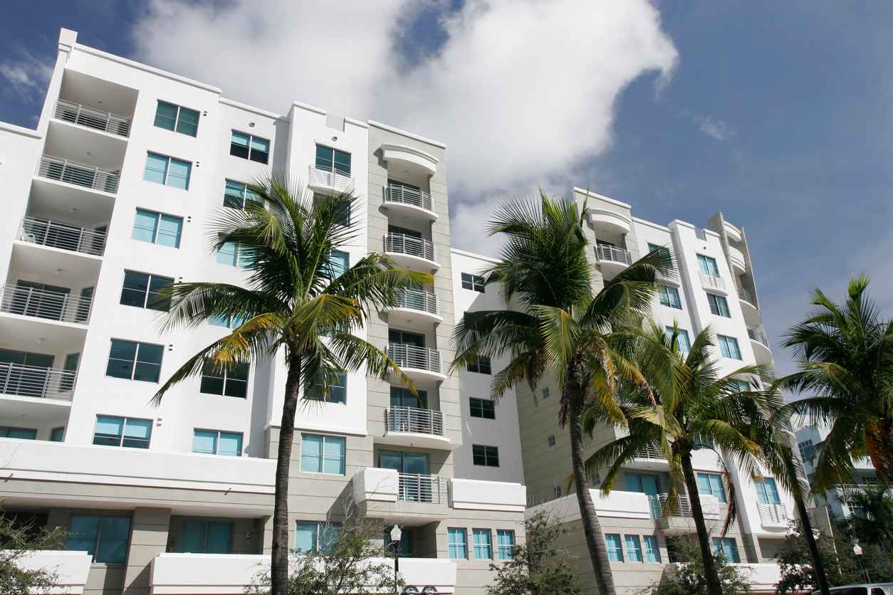 Modern condo building in Florida with palm trees