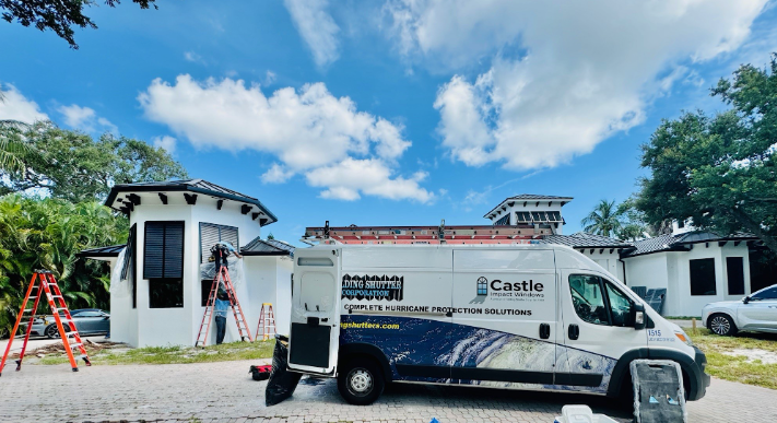 Castle Impact Windows truck on the street outside of a home